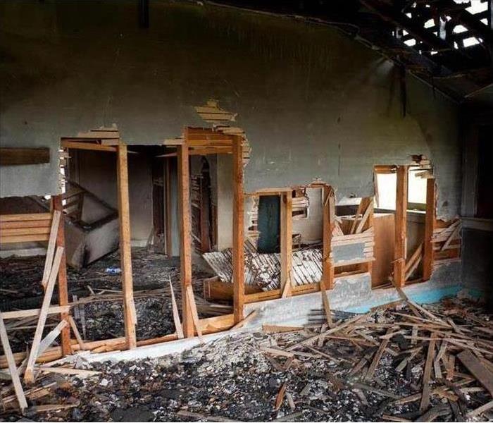 Walls broken of a home, debris on the floor
